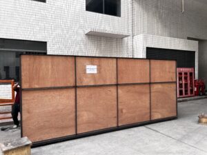 Large wooden panel blocking building entrance